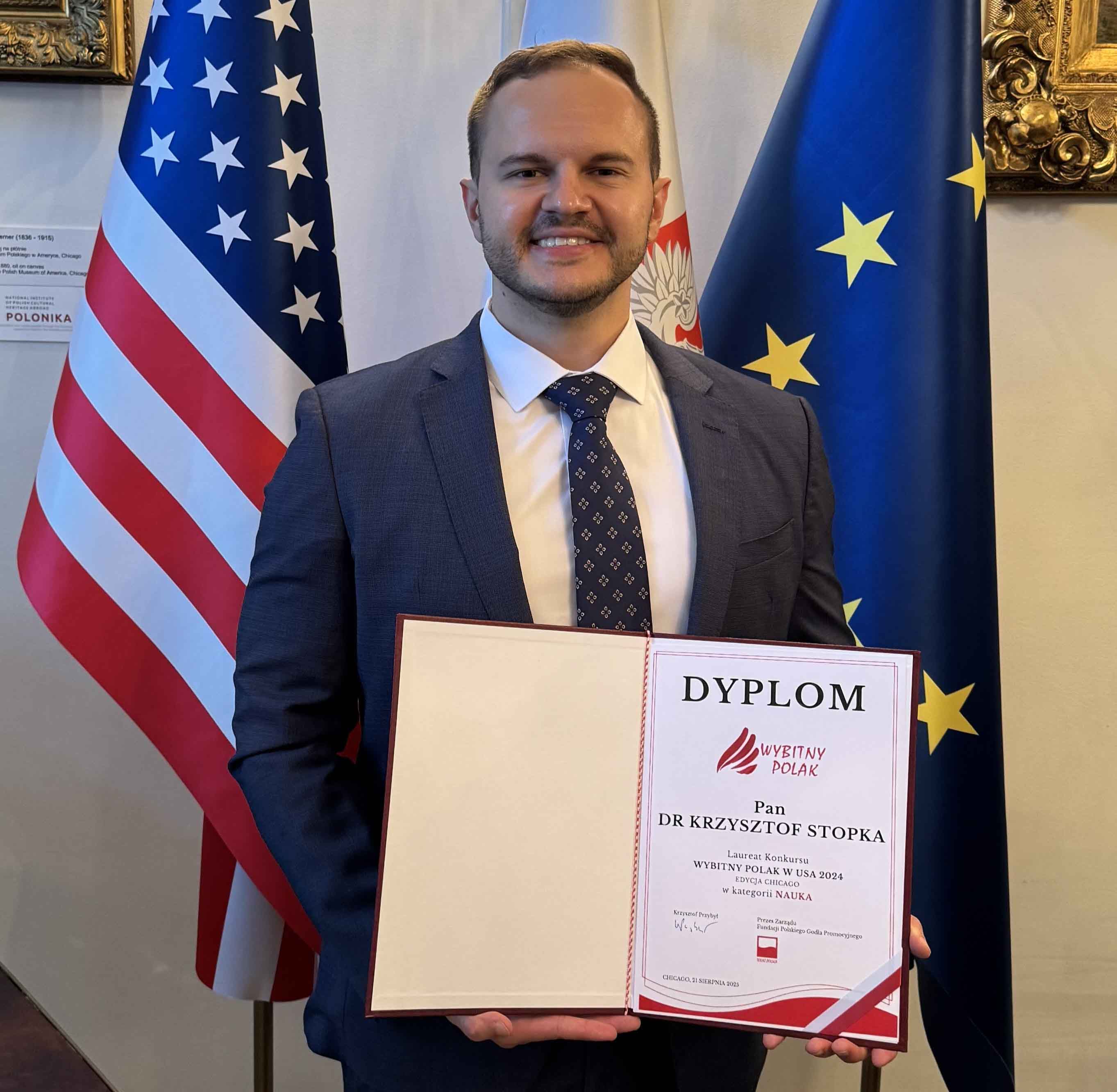 Stopka holding his award